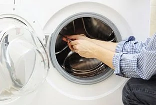 person repairing a dryer